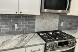 Beveled Marble Subway Backsplash with Feature Design